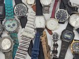 a lot of watches that are sitting on a table
