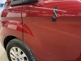 a close up of a car door handle on a red car