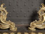 two gold colored sculptures on display in a room