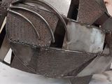 a metal sculpture of an owl sitting on top of a table