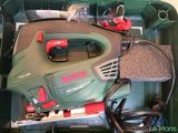 a green box with a corded cord and a tool in it