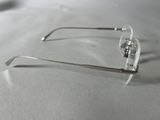 a pair of glasses sitting on a table next to a pair of scissors