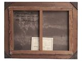 an old window frame with a piece of paper and a piece of paper