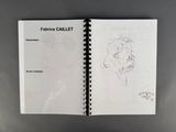 an open notebook with a drawing of a woman holding a baby