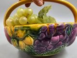 someone is holding a bowl with grapes and grapes in it