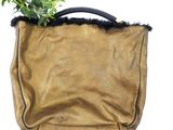 a small plant in a brown bag with a black handle