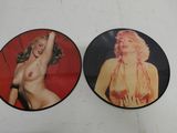 two marilyn monroe pictures on a white surface with a red background