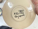 a person that is holding a plate with writing on it