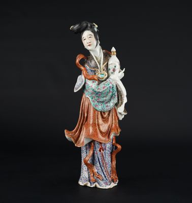 a chinese figurine of a woman holding a cat