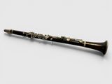 a close up of a clarinet on a white surface