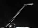 a black lamp that is sitting on a white table