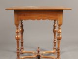 an old wooden table with two legs and a small table top