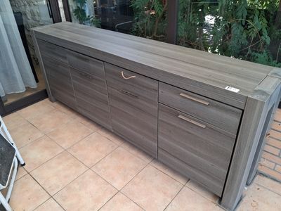 a large wooden cabinet with drawers on the floor