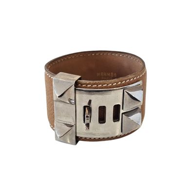 leather cuff bracelet with rivets and rivets on a white background