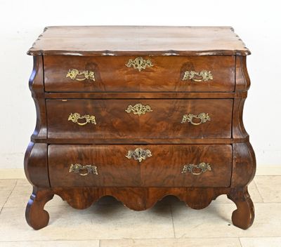 a wooden chest of drawers with brass hardware on the drawers