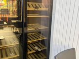 a glass door that has a wine cooler inside of it