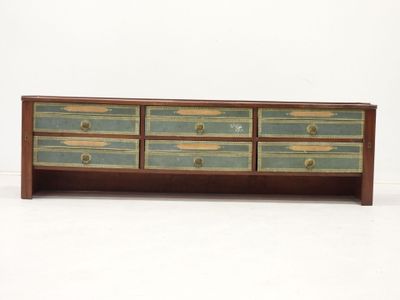 an image of a wooden dresser with four drawers on top of it