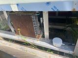 a dirty air conditioner sitting on the side of a building