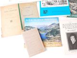 a lot of books and pamphlets on the table