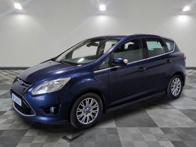 a blue ford c - max is parked on a checkered floor