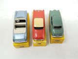 three toy cars sitting on top of each other