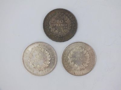 three different types of coins are shown on a white surface