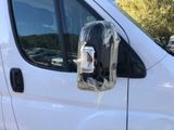 a white van with a cell phone attached to the side of it