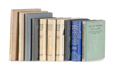 several books are lined up in a row on a white surface