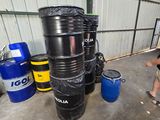 a man that is standing next to some barrels