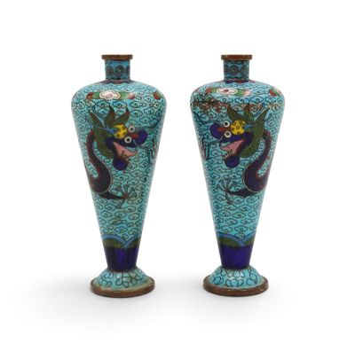 pair of blue vases with floral designs on them on a white background