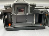a black camera that is open on a table