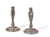 pair of antique silver candlesticks on stand on white background