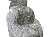 a marble chair that is sitting on a white surface
