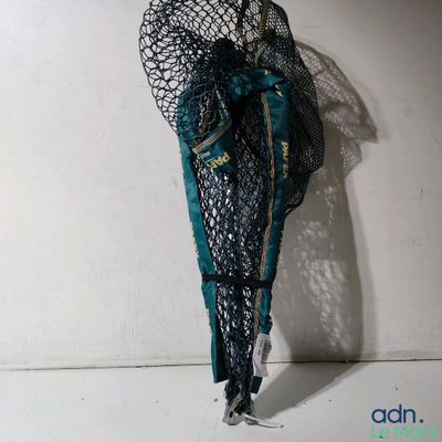 a mannequin dressed in a black and teal outfit