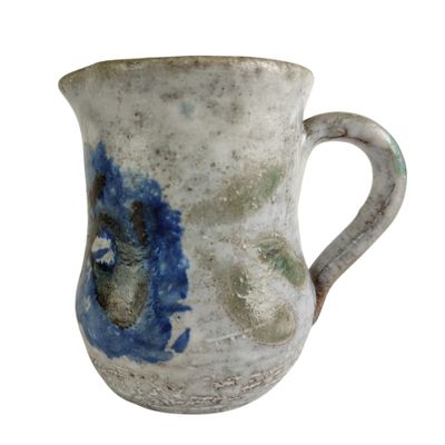 a blue and white vase with a handle on a white background