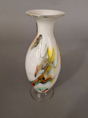 a white vase with a multicolored design on it