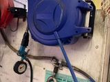 a blue hose attached to a wall next to a blue hose