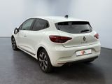 the rear end of a white car parked in a showroom