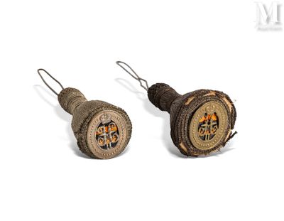 pair of antique wooden buttons with a design on them on a white background
