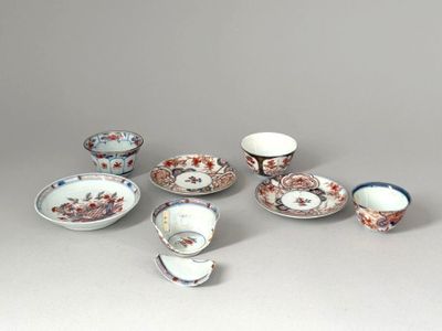 a group of porcelain dishes and cups sitting on a table