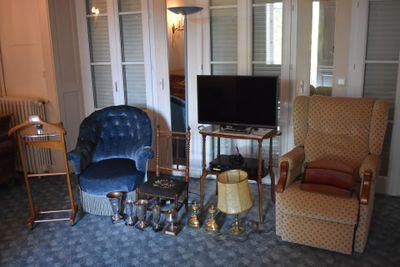 a living room with two chairs and a television in it