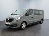 the grey van is parked in a large room with a black floor