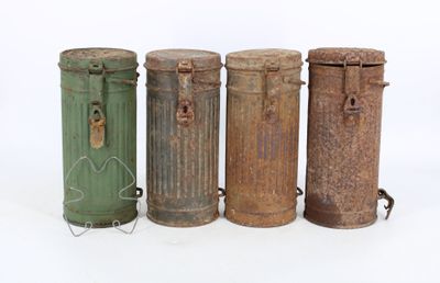three old metal trash cans sitting next to each other on a white surface