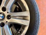 a close up of a car wheel with a tire on the ground
