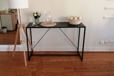 a black table with a basket on top of it