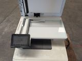 a white printer sitting on top of a stack of other printers