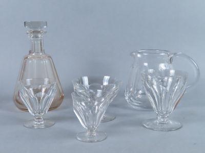 three glass vases and a decanter on a table