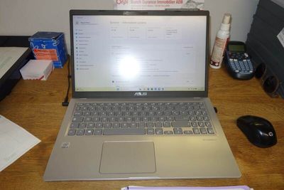 a laptop computer sitting on a desk next to a mouse