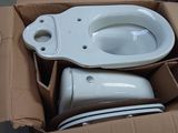 a box with a toilet and other items inside of it