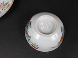a white vase with a floral design on it